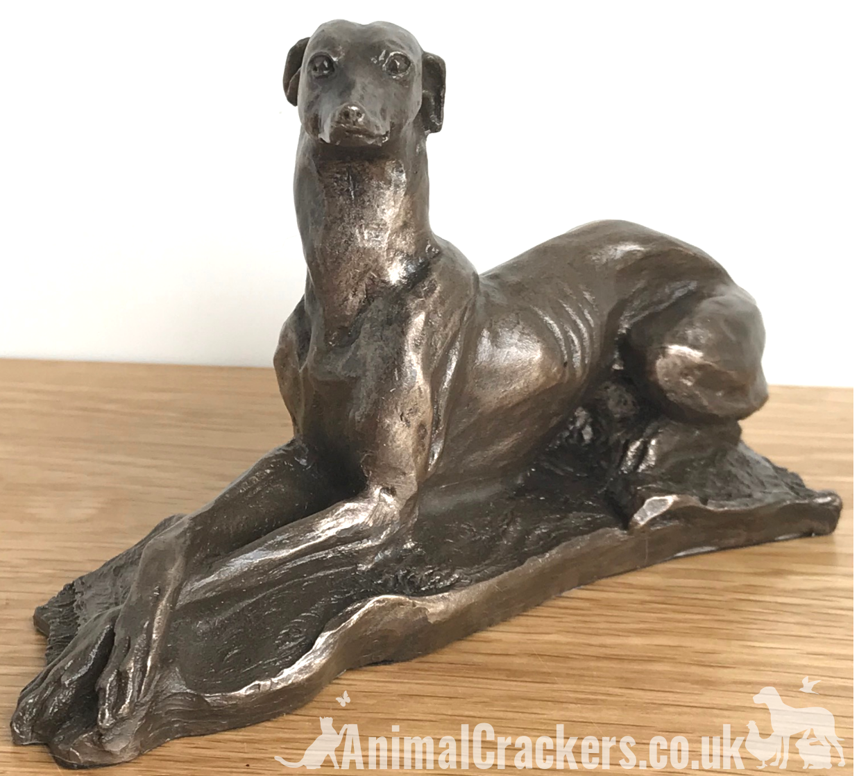 Laying Greyhound sculpture by Harriet Glen, in quality Cold Cast Bronze